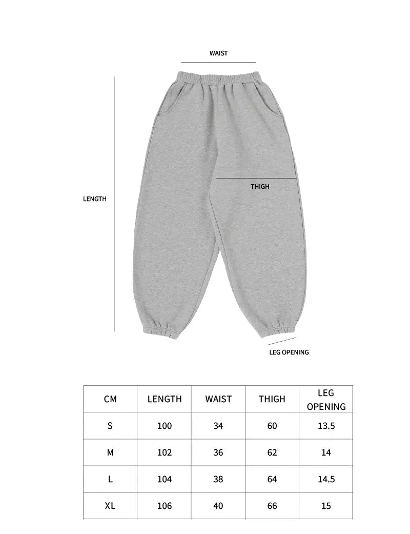 Gray sweatpants with size chart on a white background