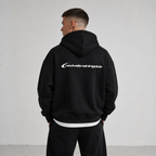 Person wearing a black hoodie with 'revivaltrainingclub' logo on the back against a plain background